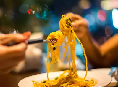 couple toasting spaghetti