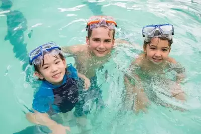 Kids playing at an indoor pool