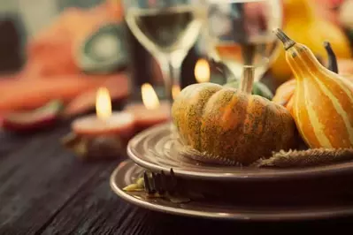 Autumn table setting with pumpkins and a gourd.