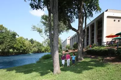 Women talking by the river at our Great Smoky Mountain hotel.