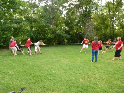 Family playing tug-of-war at The Inn on the River hotel