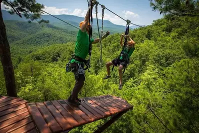 Man and boy ziplining