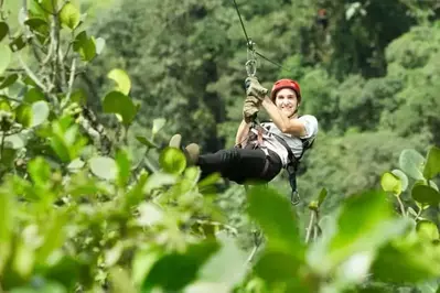 Man ziplining and smiling