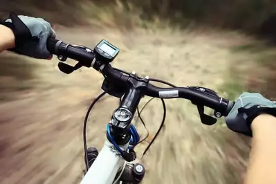 Man holding handlebars of mountain bike