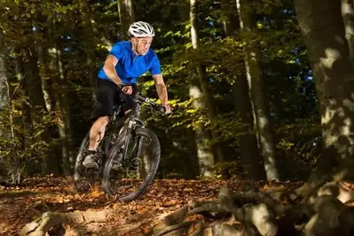 Man mountain biking in the forest