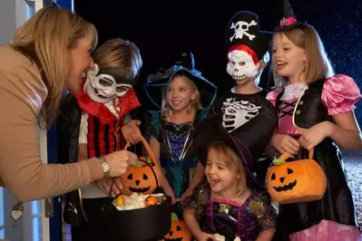 Kid trick-or-treating at a house