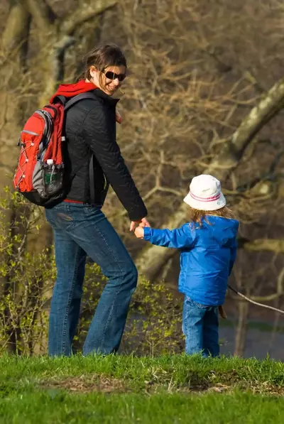 Mother and child walking on a field