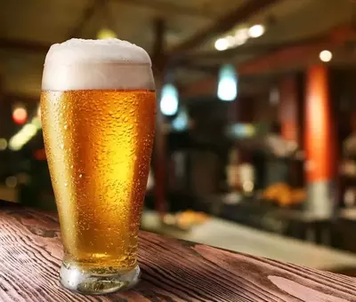 Light beer on wooden table in bar