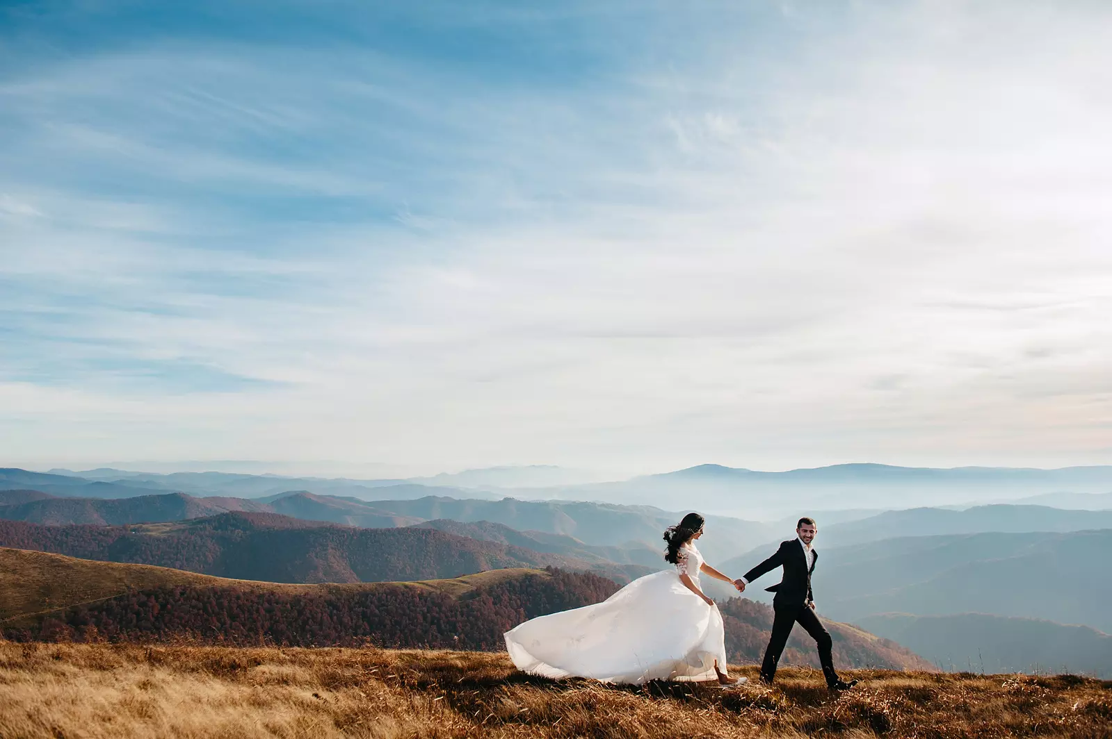 bride and groom in front of mountain view