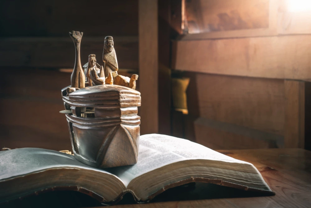 Bible with wood carving of Noah's Ark on open pages